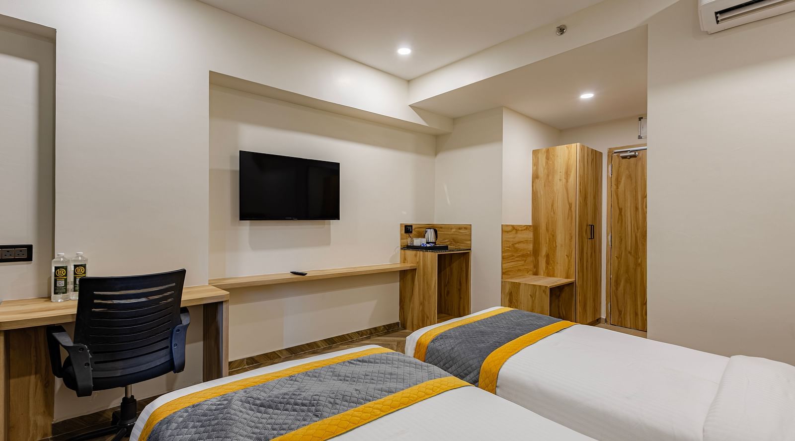 Lemonridge Hotels, KPHB | Hotel room with a work desk, chair, and a double bed. Suitable for business travelers.